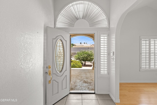 6637 Wind Ridge Dr, El Paso, TX 79912 - entrance foyer with arched walkways, healthy amount of natural light, and light tile patterned floors