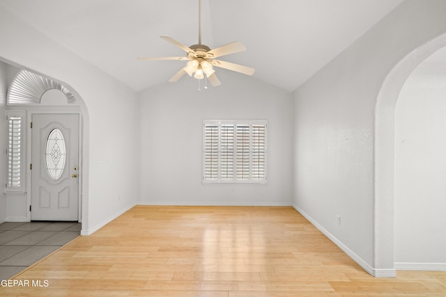 6637 Wind Ridge Dr, El Paso, TX 79912 - entryway featuring arched walkways, a ceiling fan, light wood-style floors, lofted ceiling, and plenty of natural light