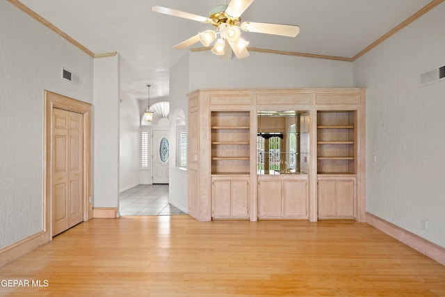 6637 Wind Ridge Dr, El Paso, TX 79912 - unfurnished living room featuring light wood-style flooring, ornamental molding, a ceiling fan, and vaulted ceiling