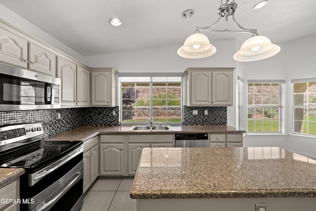 6637 Wind Ridge Dr, El Paso, TX 79912 - kitchen featuring stainless steel appliances, tasteful backsplash, healthy amount of natural light, light tile patterned floors, and recessed lighting
