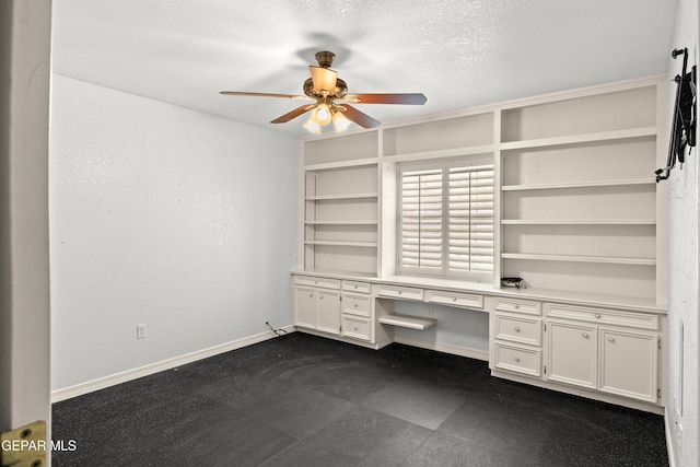 6637 Wind Ridge Dr, El Paso, TX 79912 - unfurnished office featuring a ceiling fan, built in study area, and a textured ceiling