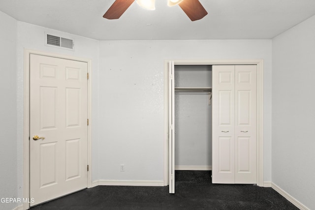 6637 Wind Ridge Dr, El Paso, TX 79912 - unfurnished bedroom featuring dark carpet, a closet, and a ceiling fan