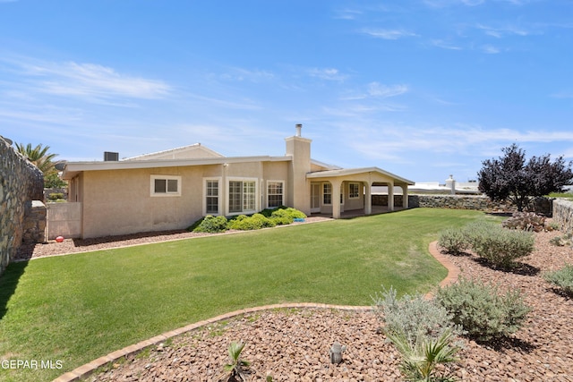 6637 Wind Ridge Dr, El Paso, TX 79912 - rear view of property featuring stucco siding and a chimney