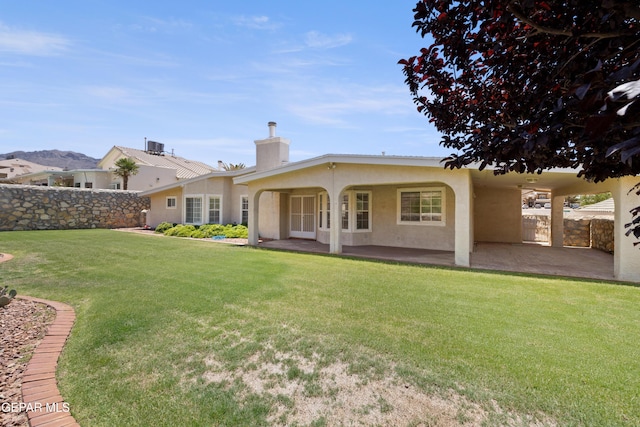 6637 Wind Ridge Dr, El Paso, TX 79912 - rear view of house with a chimney, stucco siding, and a patio