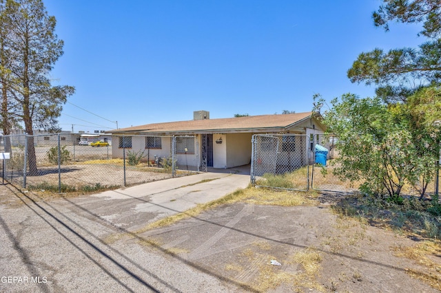 113 N Moon Rd, Socorro, TX 79927 - ranch-style house featuring concrete driveway, a gate, a chimney, and a carport