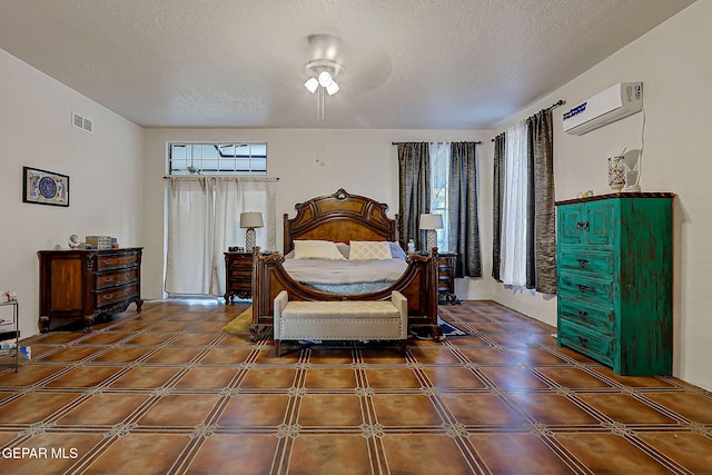 6112 Strahan Rd, El Paso, TX 79932 - bedroom with an AC wall unit and a textured ceiling
