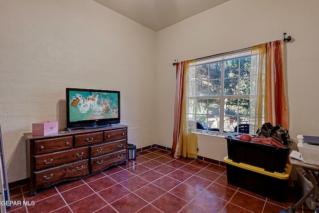 6112 Strahan Rd, El Paso, TX 79932 - sitting room featuring dark tile patterned flooring, a textured wall, and baseboards