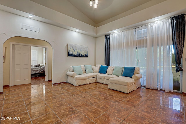 6112 Strahan Rd, El Paso, TX 79932 - living room featuring arched walkways, lofted ceiling, and baseboards