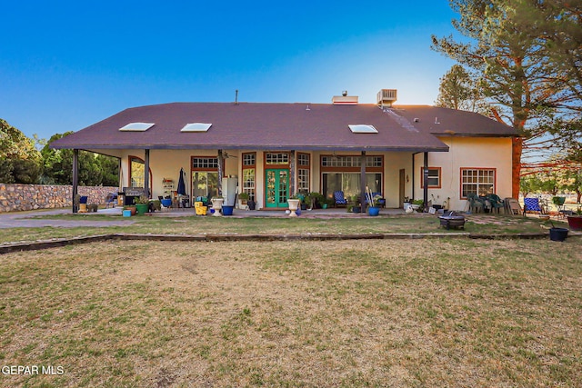 6112 Strahan Rd, El Paso, TX 79932 - rear view of property featuring a yard, a patio, stucco siding, and french doors