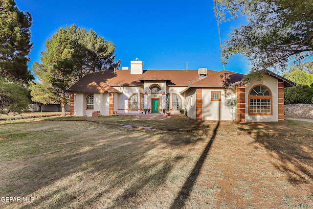 6112 Strahan Rd, El Paso, TX 79932 - back of property with a chimney, a yard, and stucco siding