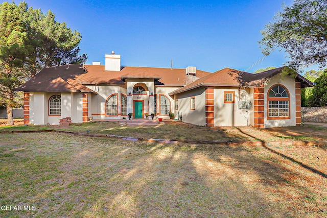 6112 Strahan Rd, El Paso, TX 79932 - mediterranean / spanish house with a chimney, stucco siding, and central AC unit