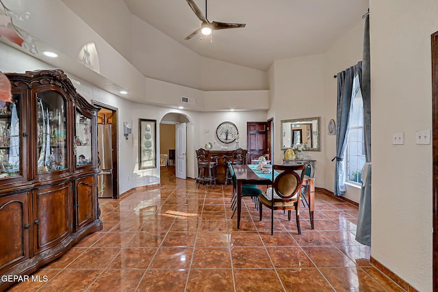 6112 Strahan Rd, El Paso, TX 79932 - dining room with arched walkways, ceiling fan, baseboards, high vaulted ceiling, and dark tile patterned floors
