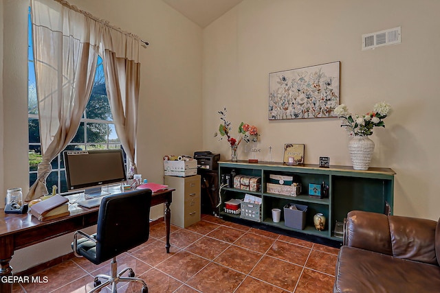 6112 Strahan Rd, El Paso, TX 79932 - office with dark tile patterned flooring and vaulted ceiling