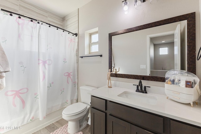 14689 Pebble Hills Blvd, El Paso, TX 79938 - full bathroom with vanity, plenty of natural light, shower / bath combo with shower curtain, and wood finished floors