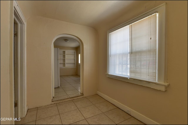 2619 Piedras St Unit A, And B, El Paso, TX 79930 - hallway featuring arched walkways, light tile patterned floors, and baseboards