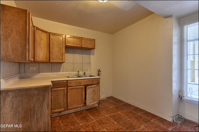 2619 Piedras St Unit A, And B, El Paso, TX 79930 - kitchen featuring a sink, brown cabinetry, light countertops, and baseboards