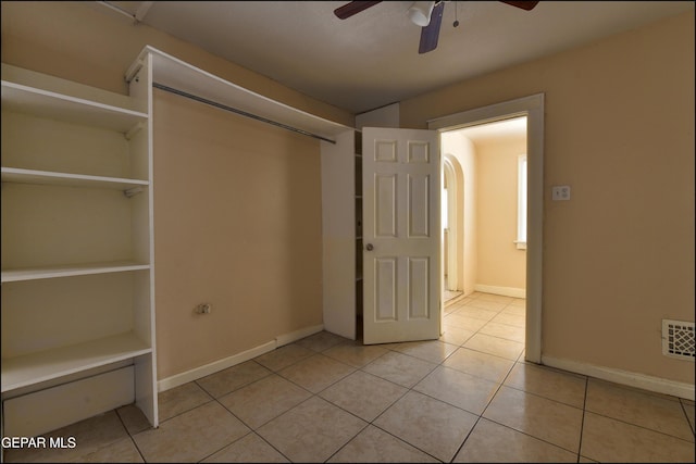 2619 Piedras St Unit A, And B, El Paso, TX 79930 - unfurnished bedroom with light tile patterned floors, baseboards, ceiling fan, and arched walkways