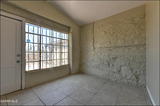 2619 Piedras St Unit A, And B, El Paso, TX 79930 - tiled spare room featuring vaulted ceiling and a textured ceiling