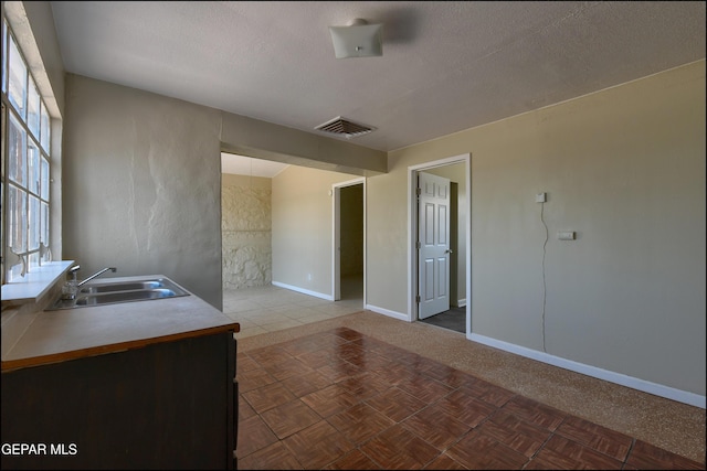 2619 Piedras St Unit A, And B, El Paso, TX 79930 - kitchen with a sink, baseboards, and a textured ceiling