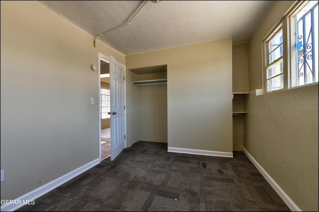 2619 Piedras St Unit A, And B, El Paso, TX 79930 - unfurnished bedroom with dark carpet, a closet, and baseboards