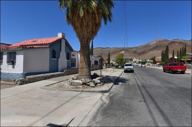 2619 Piedras St Unit A, And B, El Paso, TX 79930 - view of asphalt road with a mountain view, curbs, and sidewalks