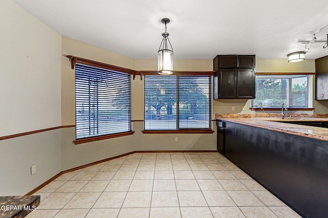 1433 Belvidere St, El Paso, TX 79912 - kitchen with a sink, decorative light fixtures, baseboards, and dark brown cabinets