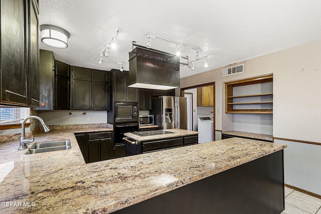 1433 Belvidere St, El Paso, TX 79912 - kitchen with a sink, appliances with stainless steel finishes, washer / clothes dryer, and light stone countertops