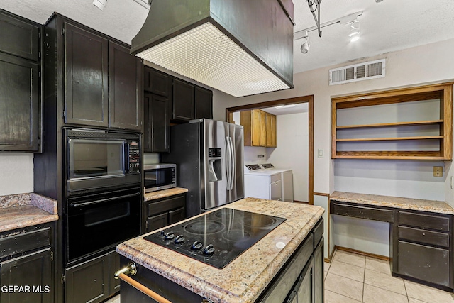 1433 Belvidere St, El Paso, TX 79912 - kitchen featuring washer and clothes dryer, black appliances, and dark cabinetry
