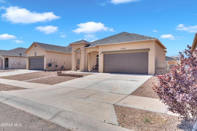 14250 Charles Pollock Ave, El Paso, TX 79938 - view of front facade featuring an attached garage, driveway, stucco siding, and roof with shingles