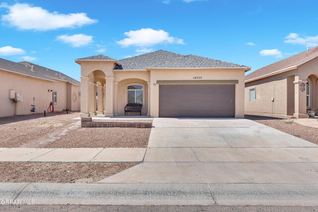 14250 Charles Pollock Ave, El Paso, TX 79938 - view of front of home with an attached garage, stucco siding, driveway, and roof with shingles