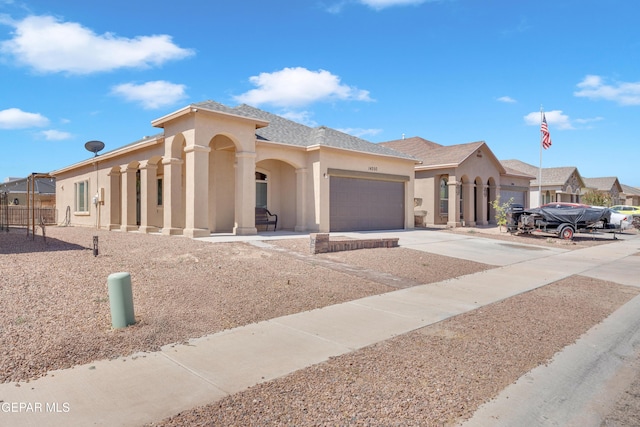 14250 Charles Pollock Ave, El Paso, TX 79938 - mediterranean / spanish home featuring stucco siding, a garage, and driveway