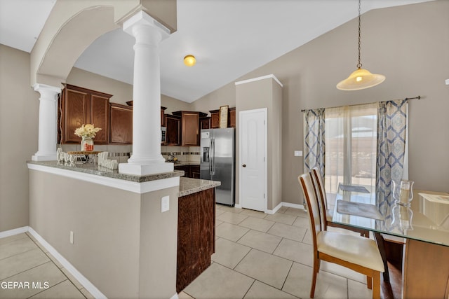 14250 Charles Pollock Ave, El Paso, TX 79938 - kitchen featuring ornate columns, appliances with stainless steel finishes, lofted ceiling, and light stone counters