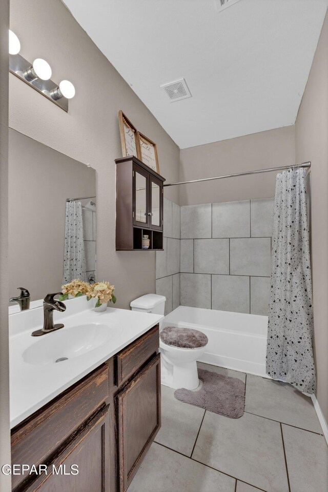 14250 Charles Pollock Ave, El Paso, TX 79938 - full bath featuring vanity, tile patterned flooring, shower / bath combo with shower curtain, and toilet