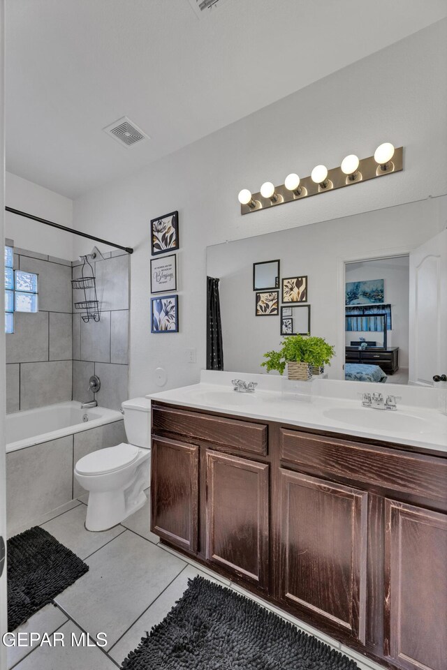 14250 Charles Pollock Ave, El Paso, TX 79938 - full bath with double vanity, tile patterned flooring, toilet, and shower / bath combination