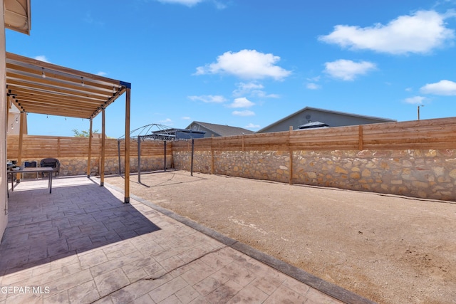 14250 Charles Pollock Ave, El Paso, TX 79938 - fenced backyard featuring a patio