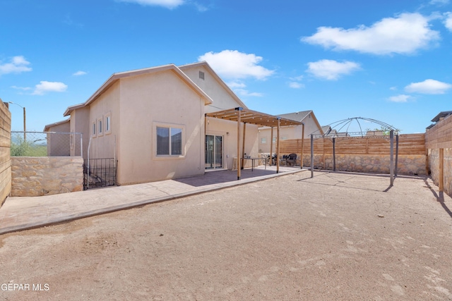 14250 Charles Pollock Ave, El Paso, TX 79938 - rear view of property featuring a fenced backyard, a patio, stucco siding, and a gate