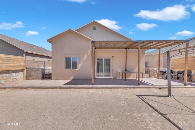 14250 Charles Pollock Ave, El Paso, TX 79938 - back of property featuring stucco siding and a patio