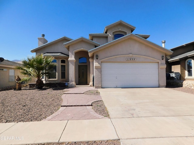 11233 Red Barrel Pl, El Paso, TX 79934 - mediterranean / spanish house with an attached garage, concrete driveway, stucco siding, and a chimney