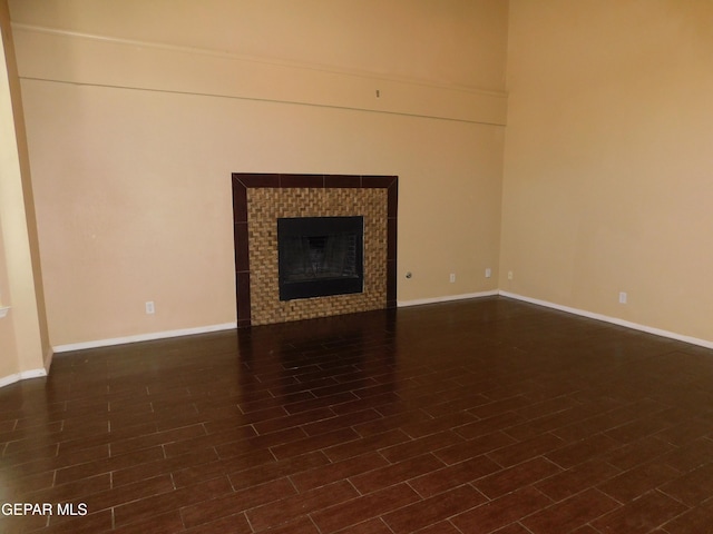 11233 Red Barrel Pl, El Paso, TX 79934 - unfurnished living room featuring a tiled fireplace and baseboards