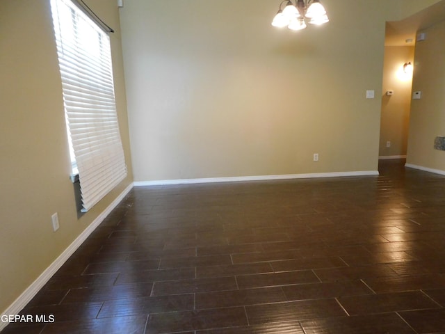 11233 Red Barrel Pl, El Paso, TX 79934 - empty room with a chandelier, dark wood-type flooring, and baseboards