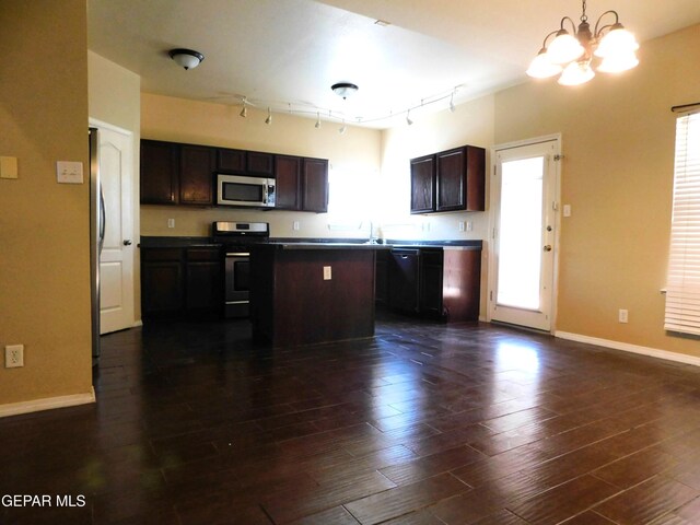 11233 Red Barrel Pl, El Paso, TX 79934 - kitchen with appliances with stainless steel finishes, baseboards, a chandelier, rail lighting, and healthy amount of natural light