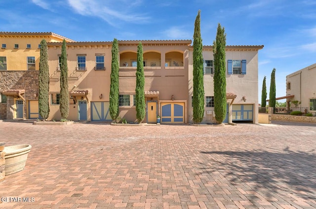 6350 Escondido Dr Unit A24, El Paso, TX 79912 - view of front facade featuring stucco siding, an attached garage, a tiled roof, and driveway