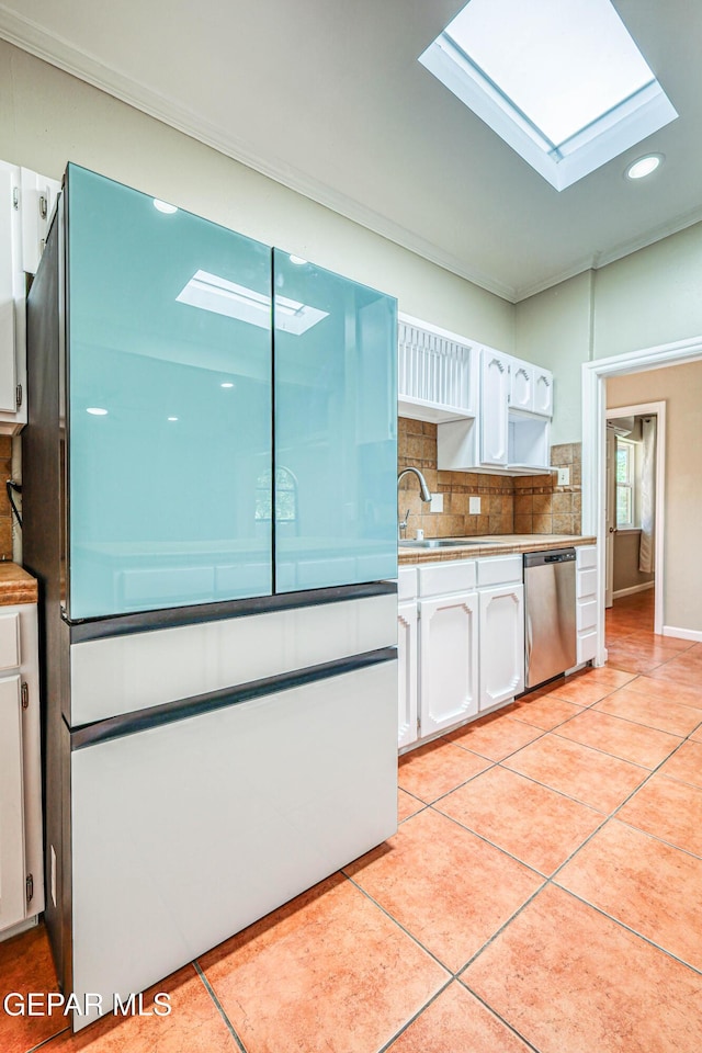 3223 Suffolk Rd, El Paso, TX 79925 - kitchen featuring a skylight, freestanding refrigerator, stainless steel dishwasher, white cabinetry, and ornamental molding