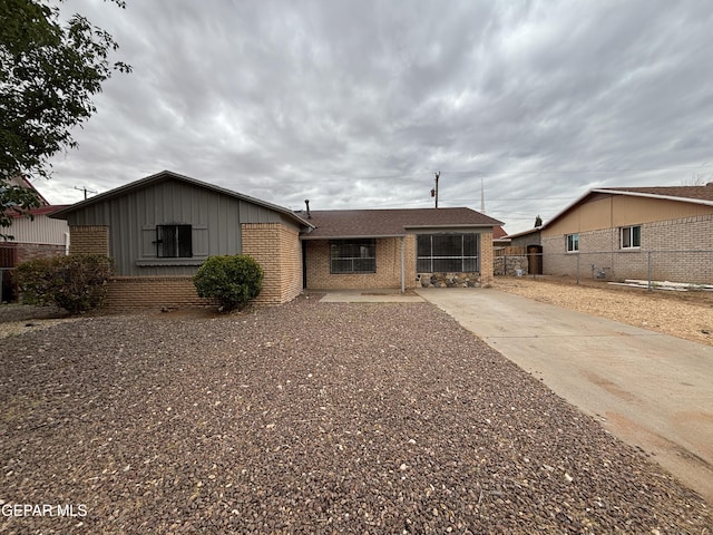 5808 Dearborne Dr, El Paso, TX 79924 - ranch-style home featuring brick siding, board and batten siding, and a shingled roof