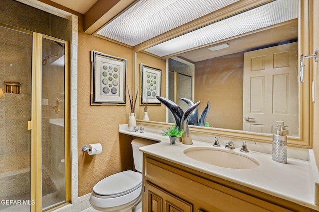 5744 Mira Grande Dr, El Paso, TX 79912 - full bathroom with toilet, a shower stall, vanity, and a textured wall