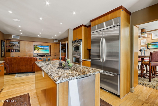 5744 Mira Grande Dr, El Paso, TX 79912 - kitchen with stainless steel built in fridge, light wood finished floors, light stone countertops, and recessed lighting