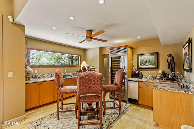 5744 Mira Grande Dr, El Paso, TX 79912 - dining space featuring light wood-style flooring, ceiling fan, wine cooler, and recessed lighting