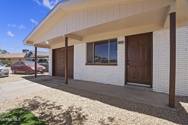 9606 Bahamas St, El Paso, TX 79927 - property entrance featuring brick siding, driveway, and a garage