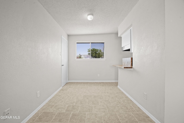 9606 Bahamas St, El Paso, TX 79927 - empty room with a textured ceiling and baseboards