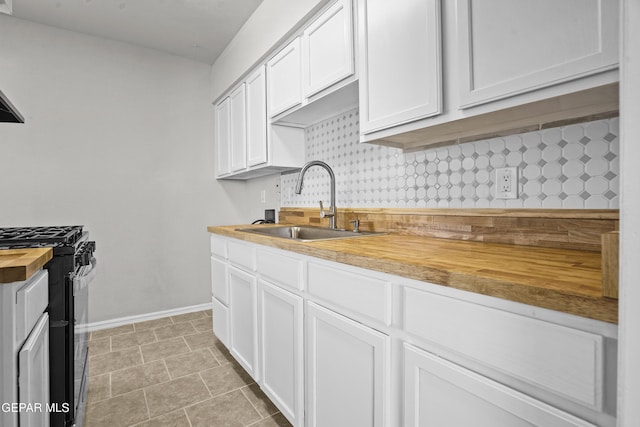 9606 Bahamas St, El Paso, TX 79927 - kitchen featuring butcher block counters, gas stove, white cabinetry, and decorative backsplash